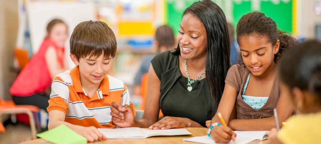 female teacher and elementary students in a classroom